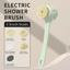White electric bath brush with all 5 brush head attachments displayed beside shower accessories
