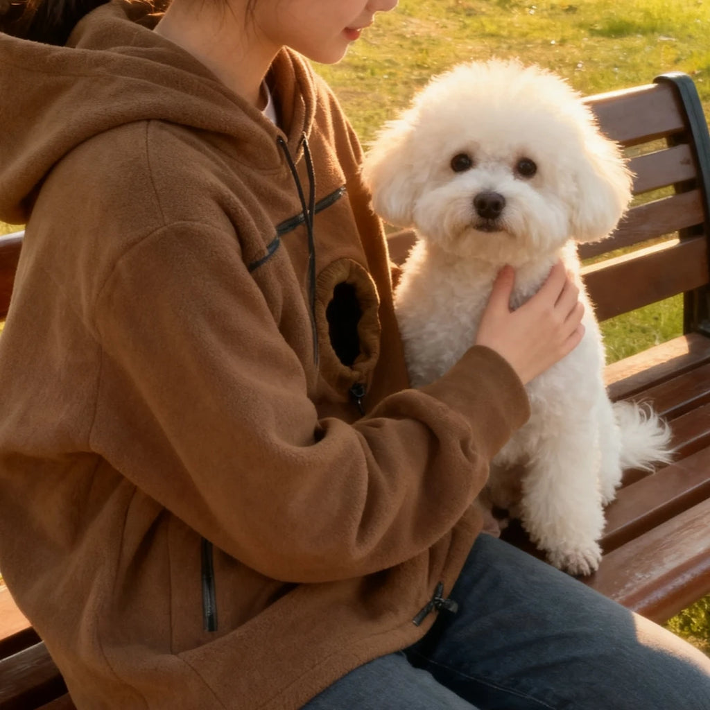 Pet carrier hoodie worn hands-free while carrying a small pet