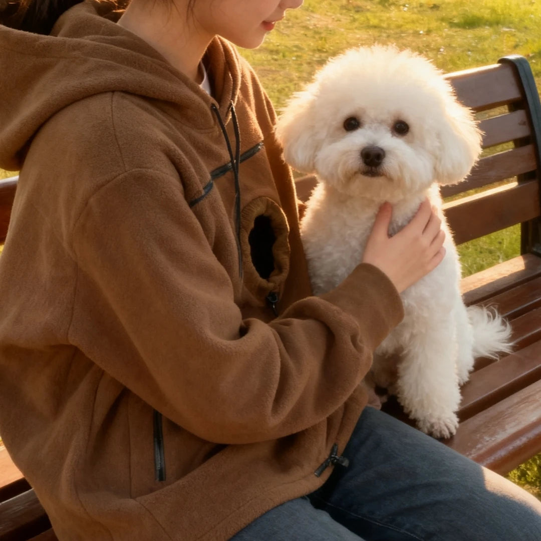 Pet carrier hoodie worn hands-free while carrying a small pet